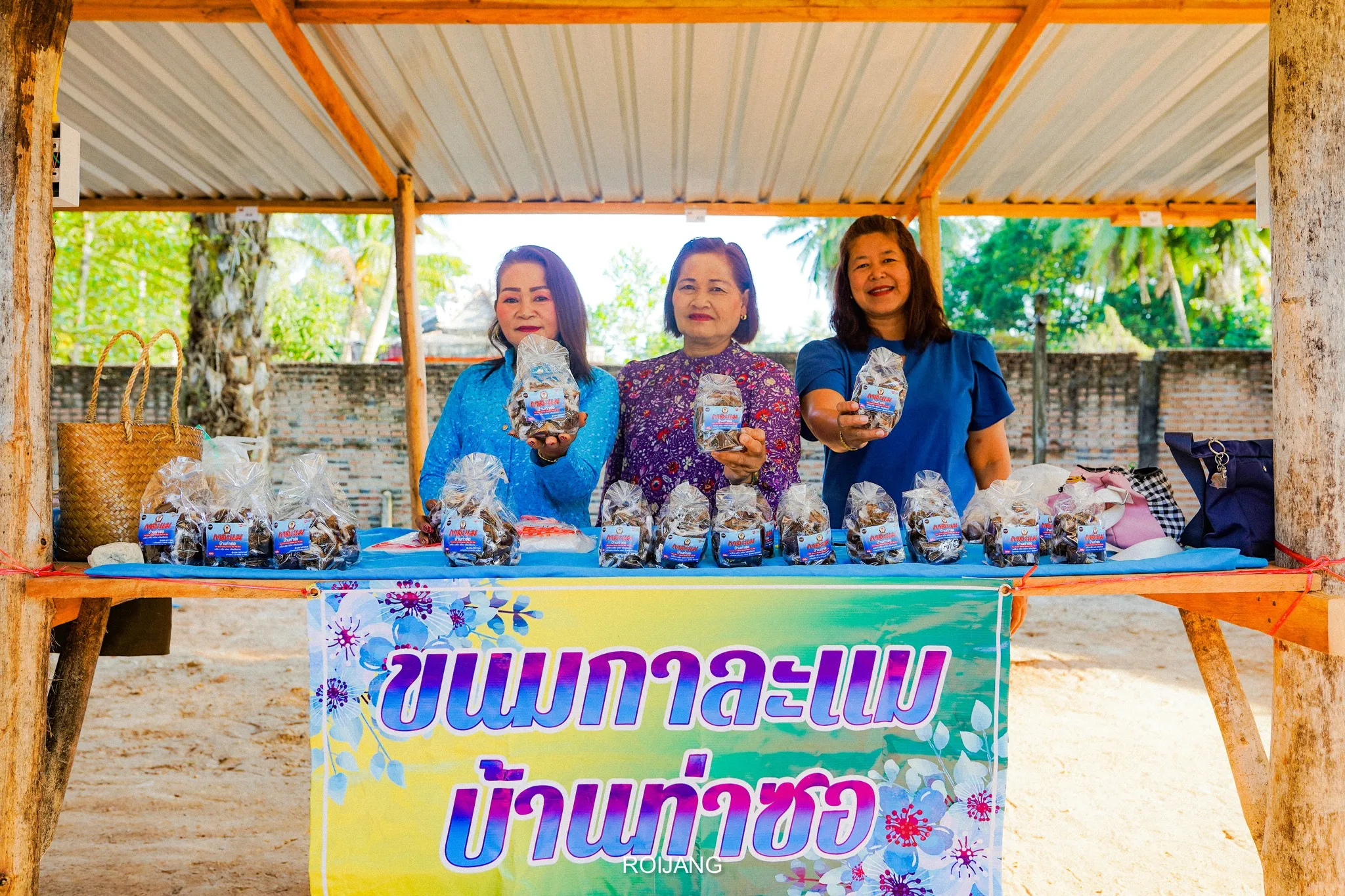 ภาพแม่ค้า 3 คนถือสินค้าขนมกาละแม ขนมดังประจำบ้านท่าซอ ท้ายเหมือง พังงา